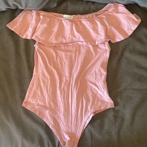 Light pink bodysuit with off the shoulder.